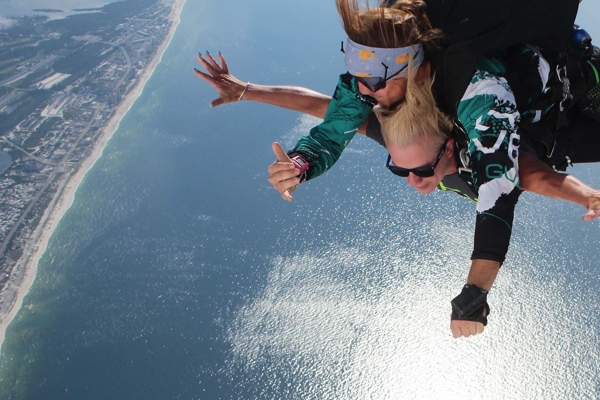 Tandem skydivers in freefall over the Gulf of Mexico 